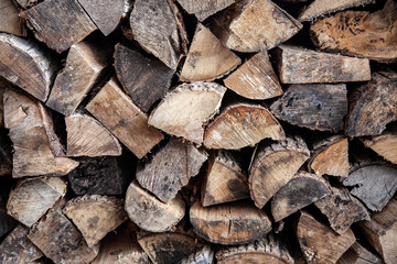 A chopped wood pile background with a well dried mix of hardwood and softwood ready for a winter fireplace.