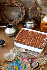 Homemade tiramisu. Wooden background. Side view. Cake and coffee.