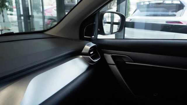 On the armrest the buttons for the electric elevating mechanism of windows in door of the car. Luxury car.