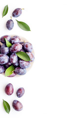 Food layout with plums in bowl with leaves. Top view