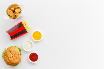 Fast food set. Hamburger and fries with sauces - takeaway