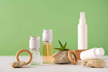 Fototapeta na wymiar Set of cosmetics products on a green background