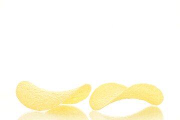 Delicious light yellow potato chips, close-up, isolated on white.