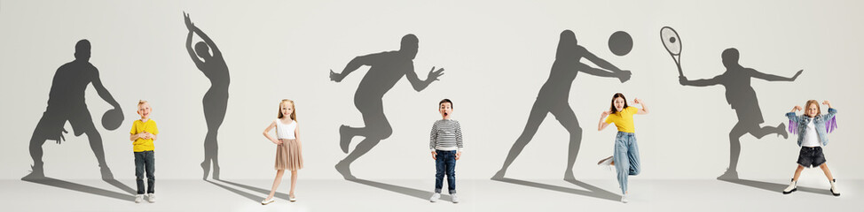 Collage. Dreams about big and famous future. Conceptual image with little boys and girls and shadows of fit professional sportsmen on light gray background