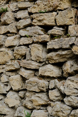 Fototapeta premium a stone wall. Stone wall background. The stones are stacked in the wall.
