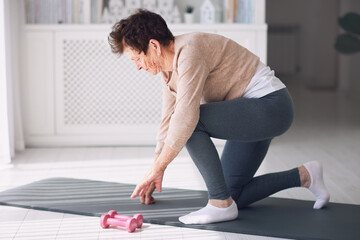 athletic mature woman exercising at home, active lifestyle, 84 years old lady workout
