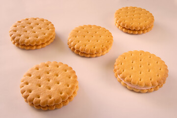 biscuits with filling on a pink background