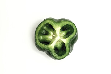 Green pepper cut in half to show its inner cavities.