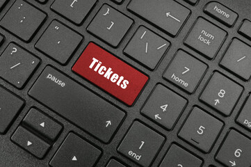 Buy tickets online concept, laptop keyboard with tickets button