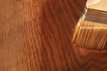 Painting a wooden surface with varnish, a brush on an oak board.