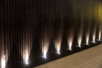 number of night lamps lighting decorative slats of the cafe wall