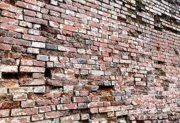 Old crumbling brick wall as an abstract