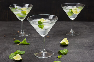 Three misted wine glasses filled with lime, mint and ice