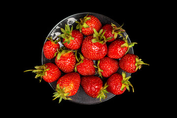 ripe red tuber on a black background view from top