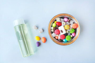 Feast Concept, Traditional Turkish Ramadan sweet sugar in bowl and cologne bottle on blue...