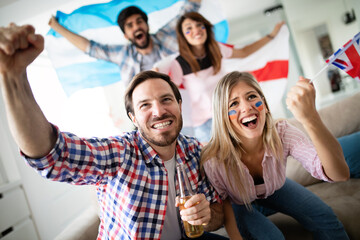 Cheerful and happy group of friends watching olympic games on tv.