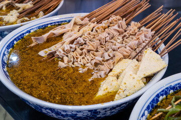 Spicy kebabs with seasoning in the bowl