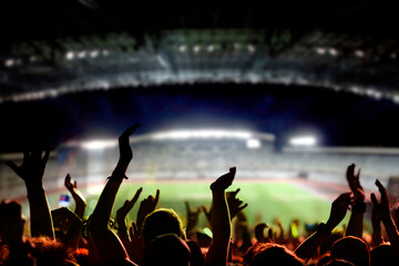 Fototapeta football or soccer fans at a game in a stadium obraz