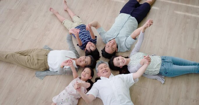 Happy family lying on floor in a circle,4K