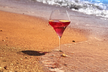 Wine glass with a cocktail by the sea.