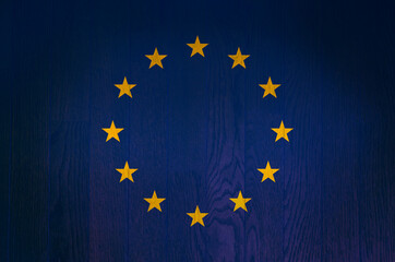 The flag of the European Union on a grunge wooden background.