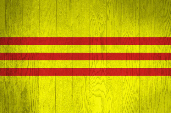 The flag of South Vietnam on a grunge wooden background.