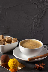 Cup of coffee and beans on table background. Set of coffee and sweets