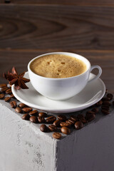 Cup of coffee and beans on concrete grey cube as  background texture.  Abstract break concept