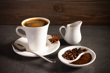 Cup of coffee and beans with ingredient on table background texture. Break coffee time