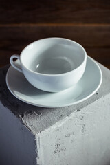 Empty cup of coffee on concrete grey cube as  background texture.  Abstract concept of break