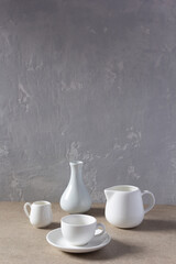 Empty crockery set or ceramic dishes. White kitchen dishware and tableware on table