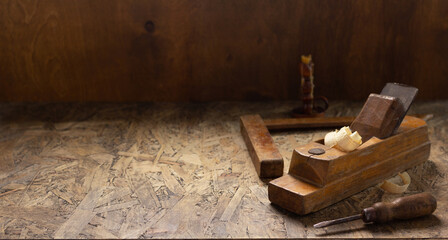 Fototapeta na wymiar Woodworking tools on wooden table. Wood plane jointer carpenter tools or joiner tool as still life