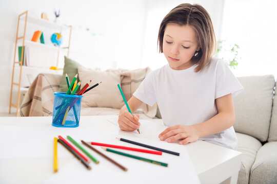 Photo of young attractive school girl concentrated focused moody paint picture pencil sit couch home
