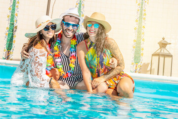 Plakat young women and a man make a party in a pool in summer