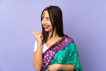 Fototapeta premium Young Indian woman isolated on purple background intending to realizes the solution while lifting a finger up