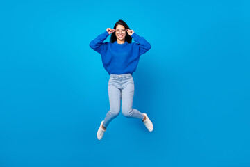 Full length body size side profile photo woman jumping up casual clothes isolated vibrant blue color background