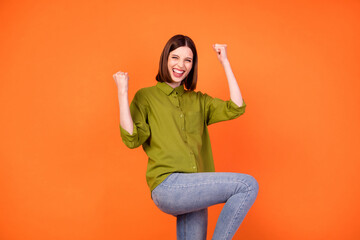 Photo of hooray bob hairdo young lady hands fists wear green shirt isolated on orange color...