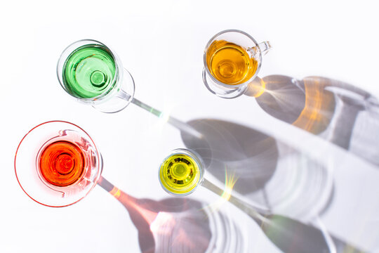 Different types of glasses with colorful liquid inside