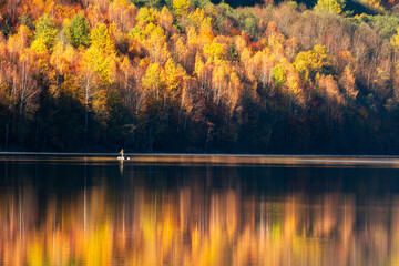 Autumn landscape, forest reflecting in lake