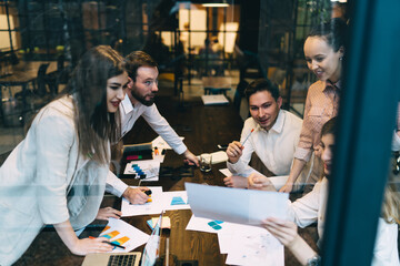 Group of colleagues discussing work plan in office