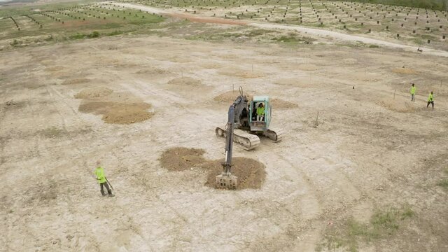 Malaysia, June 07, 2020 : Aerial view of backhoe is digging grove in the agricultural garden area to grow durian aerial. 4k footage
