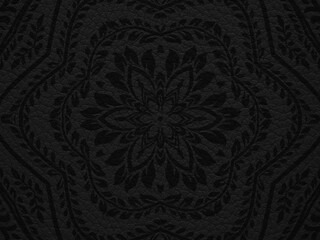 Black background like leather texture with folk motif. 