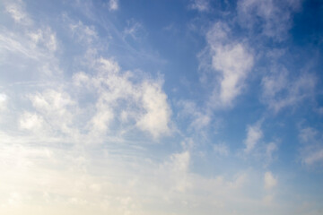 Fluffy cotton candy clouds in blue sky - replacement or background.