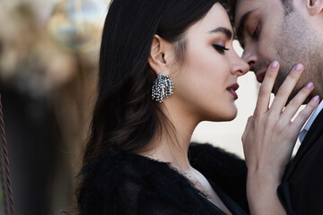 young elegant woman touching face of man