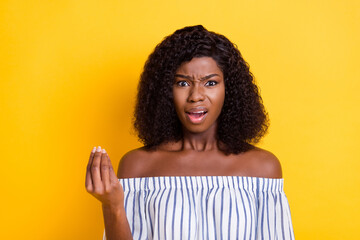 Portrait of attractive mad irritated girl saying you pretense isolated over bright yellow color...