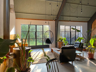 Trendy interior with a retro touch. Midcentury modern furniture, concrete floor. Design classics....