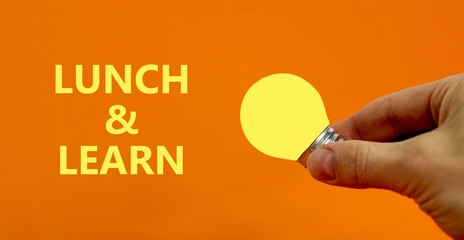 Lunch and learn symbol. Businessman holds yellow shining light bulb. Words 'Lunch and learn'....