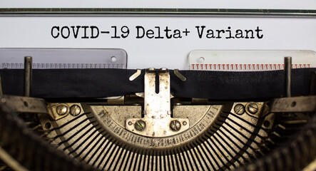 Covid-19 delta plus virus variant symbol. Words 'Covid-19 delta plus variant' typed on retro...