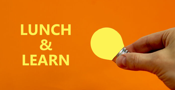 Lunch and learn symbol. Businessman holds yellow shining light bulb. Words 'Lunch and learn'. Beautiful orange background. Business, educational and lunch and learn concept. Copy space.