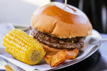 Hamburger with corn and fries
